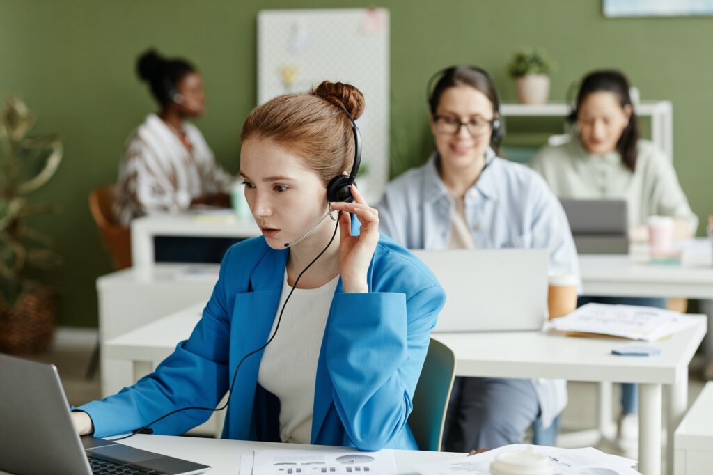 Female customer support operator working at office